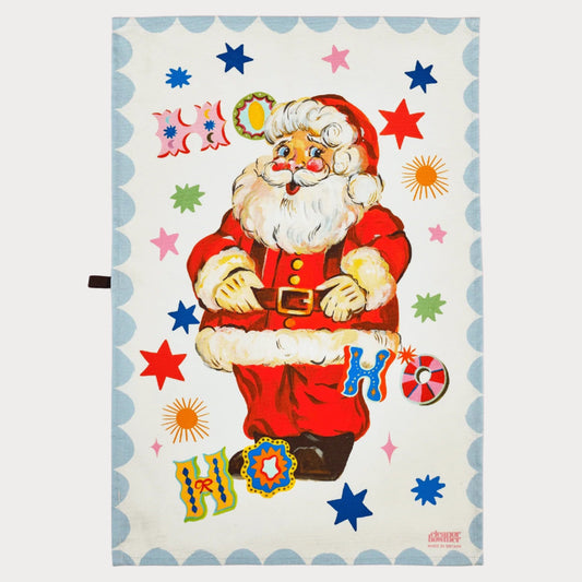 Vintage-style Santa Claus tea towel with colourful text and stars on a pink background