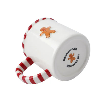 White mug with red and white striped handle featuring a gingerbread man design on a white background