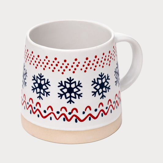 White mug with red and blue snowflake pattern on a white background