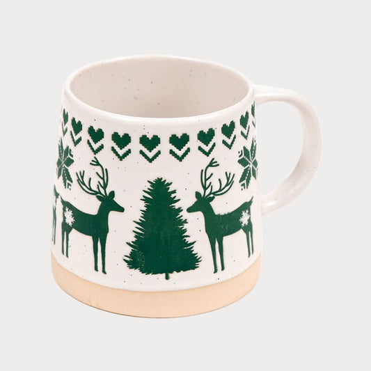 White mug with green deer and tree pattern on a white background