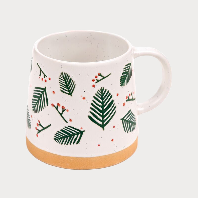 White mug with green Christmas tree and red berries pattern on a white background