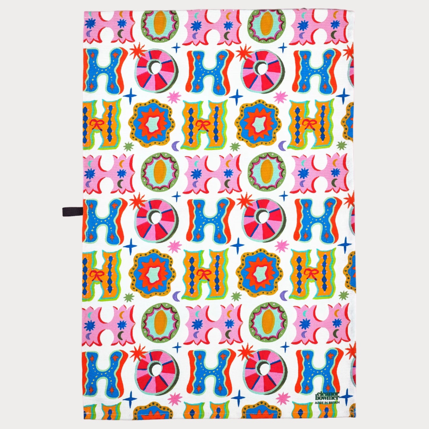 Colorful 'HO HO HO' patterned paper on a pink background