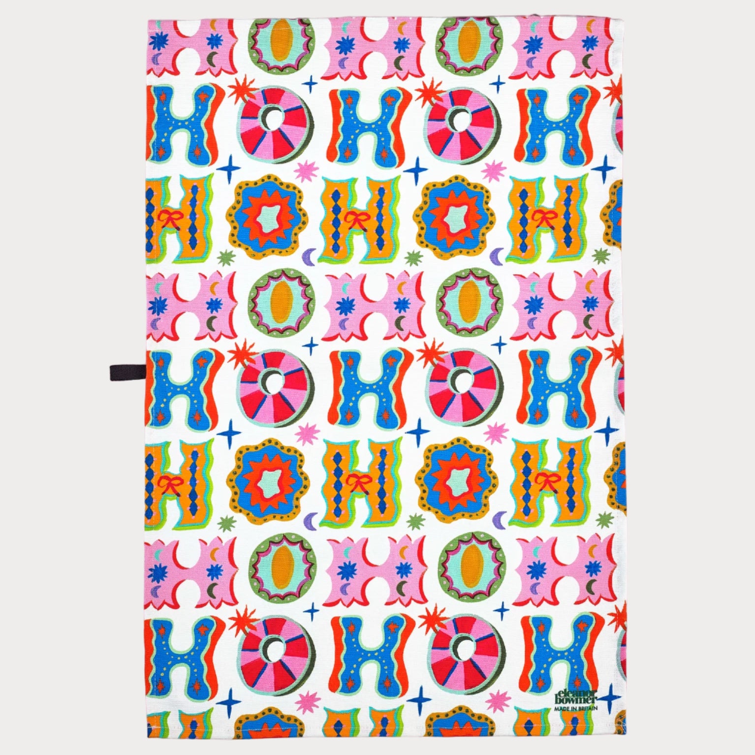 Colorful 'HO HO HO' patterned paper on a pink background